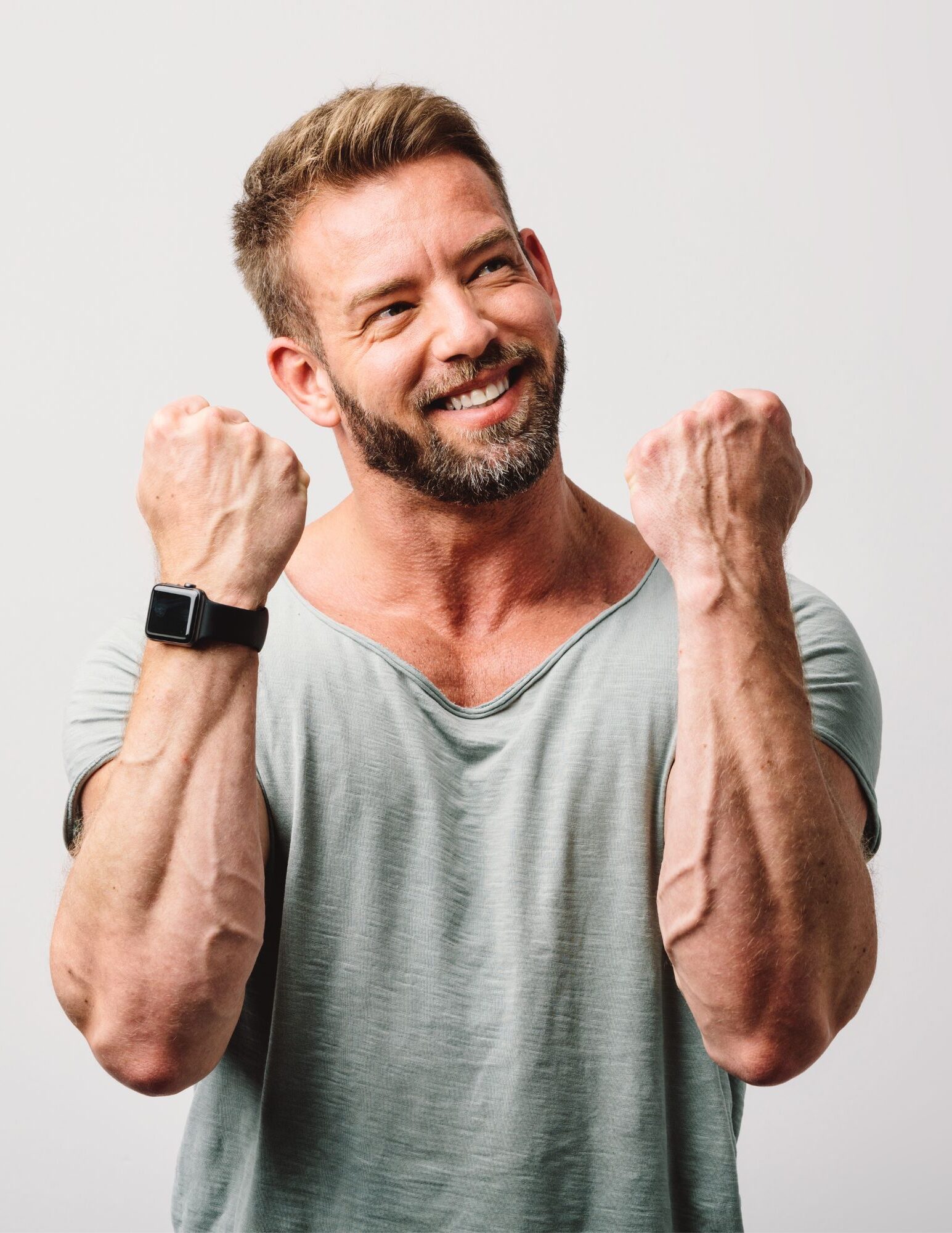 Man showing his strong arms and a happy face