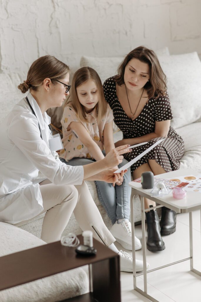 Doctor explaining medical results to a mother and her daughter